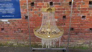 A large Empire style gilt and crystal glass chandelier