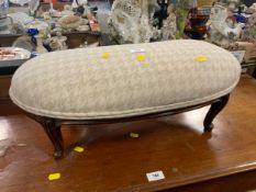 A small kidney shaped footstool