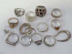 A bag of assorted white metal dress rings