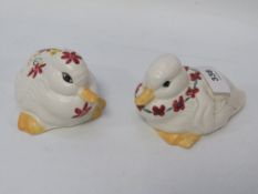 Two Poole pottery ducks, with hand painted flower decoration (2)