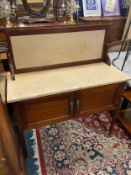 An antique mahogany marble topped washstand