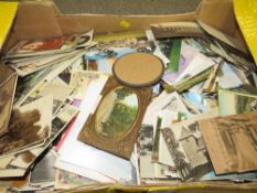 A box of vintage postcards etc