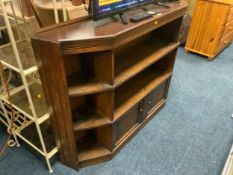 An oak angular bookcase with cupboards below