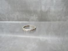 AN UNMARKED WHITE METAL DIAMOND SET ETERNITY RING, size Q, approximate weight 3.3 g