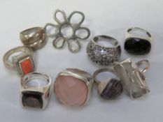 An assortment of white metal dress rings