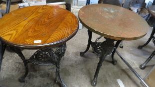 A pair of cast aluminium vintage style pub tables