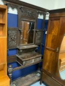 A Victorian heavily carved oak mirrored hall stand. S/D