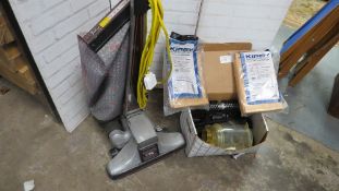 A Kirby upright vacuum cleaner and accessories