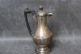 A HALLMARKED SILVER WATER JUG, hallmarks are indistinct but stamped Goldsmiths & Silversmiths Ltd to