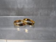A 9CT GOLD PLAIN WEDDING BAND, size N, approximate weight 2.3 g, together with another similar band,