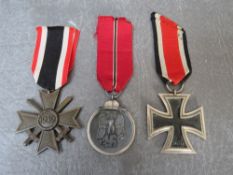 A THIRD REICH THREE MEDAL GROUP, comprising Iron Cross, War Merit service Cross and Russian Front