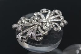 A DIAMOND CLUSTER BROOCH, set in unmarked white metal being tested as platinum confirmed by historic