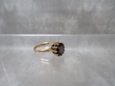 A 9CT GOLD GEMSET DRESS RING, a deep blue sapphire ? in twelve claw setting, ring size O,