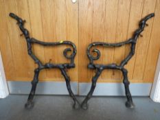 A PAIR OF CAST IRON BENCH ENDS IN THE FORM OF BRANCHES, in the style of Coalbrookdale
