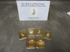 A SET OF SIX 'THE WORLD OF PETER RABBIT' 24ct GOLD PLATED INGOTS, with engraved quotes to obverse,