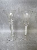 TWO GEORGIAN WINE GLASSES WITH AIR TWIST STEMS, one with etched vine and leaf detail, tallest H 17