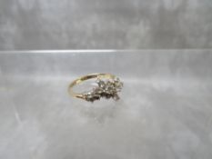 A 14K STYLISED CLUSTER DRESS RING, set with cubic zirconia stones, ring size Q ½, approximate weight