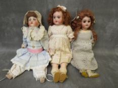 THREE VINTAGE PORCELAIN HEADED DOLLS, to include an Armand Marseille 2/0 (3200) example, tallest H