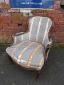 A LOUIS XV STYLE CARVED ARMCHAIR, with classical striped upholstery, (in need of re-upholstery)