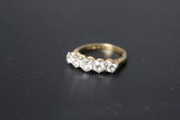 A FIVE STONE DIAMOND RING, the brilliant cut diamonds being of a estimated 0.75 carats in total