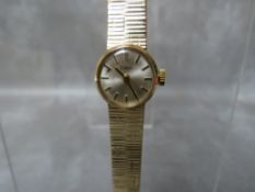 A LADIES 9CT GOLD ZODIAC DRESS WATCH, with integral bark effect bracelet, in a blue Rotary box,