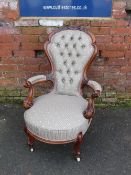 A VICTORIAN CARVED OPEN GENTLEMANS ARMCHAIR, with button back upholstery