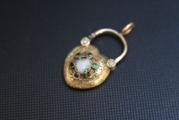 AN UNMARKED YELLOW METAL HEART SHAPED MOURNING LOCKET, set with a central opal (damaged) which is