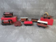 TWO O GAUGE CLOCKWORK STEAM LOCOMOTIVES. one with tender, together with five pieces of rolling