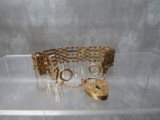 A VINTAGE 9CT GOLD FIVE BAR GATE BRACELET, with heart shaped lock clasp, fitted with safety chain, L