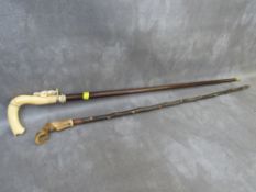 A VINTAGE BONE HANDLED WALKING CANE IN THE FORM OF A HOOF, together with another bone handled
