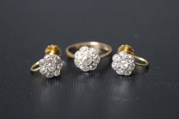 AN EIGHT STONE DIAMOND 'FLOWER' RING, set with eight old cut diamonds in a milligrain setting in