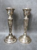 A PAIR OF HALLMARKED SILVER CANDLESTICKS, having filled bases, Birmingham 1924, H 16 cm