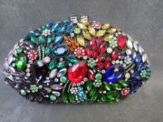 A VINTAGE BUTLER & WILSON HEAVILY EMBELLISHED CLUTCH BAG, with attached carry chain to interior, W21