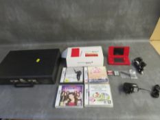 A BOXED NINTENDO DSi, with leads and games