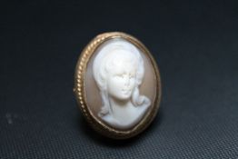 A LARGE HALLMARKED GOLD CAMEO RING, set in a raised gallery, approx weight 11.9g, rig sizen O 1/2
