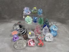 Two boxes of assorted glass paperweights