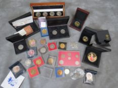 A box of modern commemorative coins and medallions, many cased to include fantasy and colour types