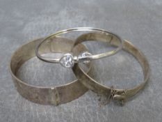 Two vintage hallmarked silver hinged bangles, approximate combined weight 50.2 g, together with a
