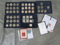 A collection of modern commemorative crown sized coins and medallions, to include examples from Isle