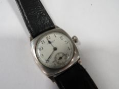 An antique military wristwatch by Waltham, the silver case by Denison Birmingham 1929