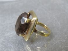 A mid century style 9ct gold dress ring, set with an oval smokey quartz type stone, ring size M,