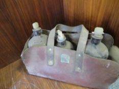Three apothecary bottles in a leather carry case A/F
