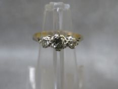 An 18ct gold three stone diamond ring, ring size N ½, approximate weight 2.19g