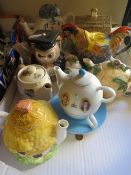 A tray of novelty tea pots