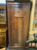 A vintage oak single door wardrobe