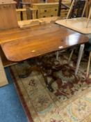 An antique oak tilt top pedestal table together with a rustic stool