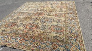 A large vintage woollen rug, with cream, black multi coloured pattern