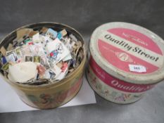 Two vintage Quality Street tins containing a selection of stamps