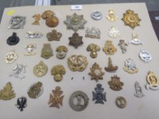 A card of 39 military badges, including Lovats Scouts, 9th Lancers etc