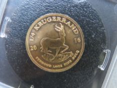 A 2016 ¼ Kruggerand gold coin, in 'management coin portfolio' plastic case